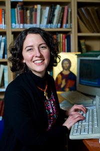 Image of IOCS student smiling while typing.