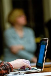 Image of student hand and laptop.
